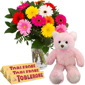 Mix gerberas with bear and chocolates