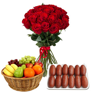 Red roses in bouquet with fruit basket and sweet