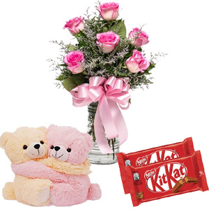 Pink roses with chocolate and candle